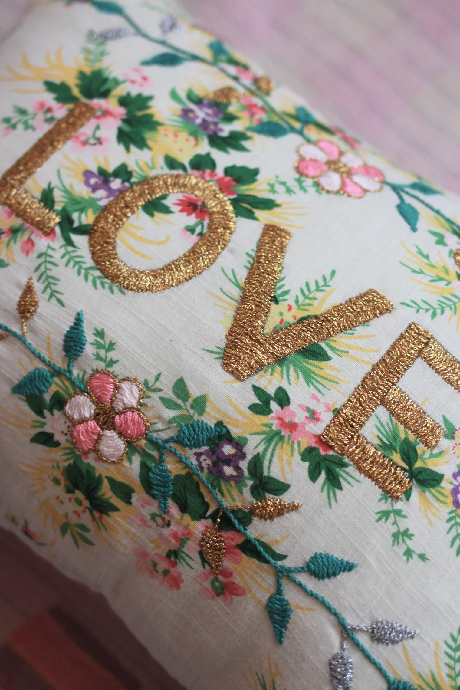 Floral linen cushion with gold embroidered 'LOVE' and colorful embroidered flowers