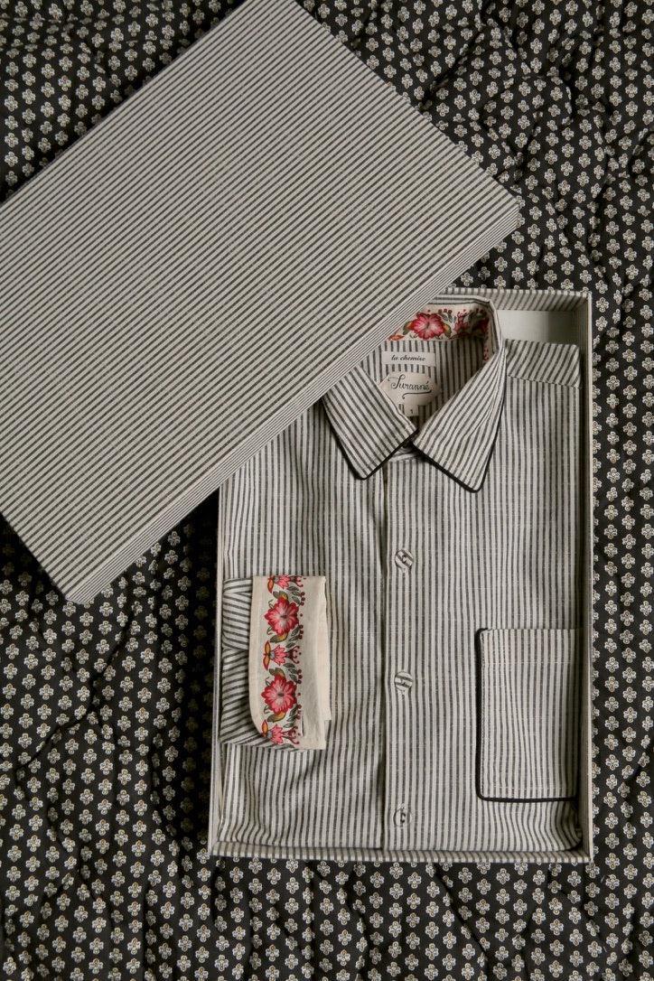 Striped cotton shirt with floral cuff detail in gift box on patterned fabric background