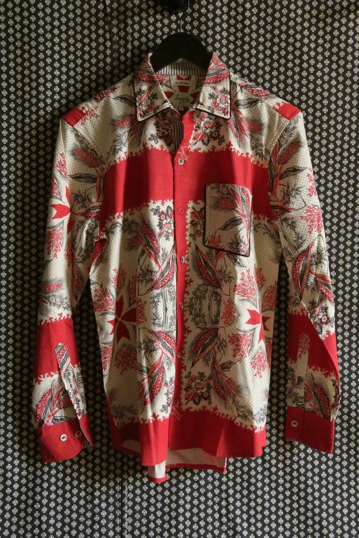 Red and cream long sleeve shirt with floral and geometric print, button-up style, hanging on a black hanger.