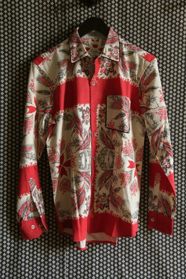 Red and cream long sleeve shirt with floral and geometric print, button-up style, hanging on a black hanger.