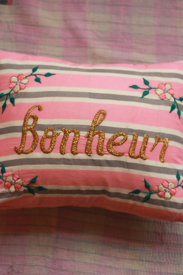 Pink and grey striped cushion with 'Bonheur' gold embroidery and floral accents