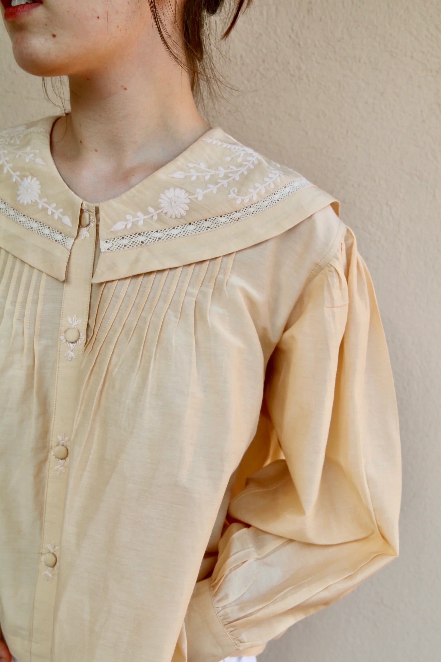 Butter-colored blouse with embroidered sailor collar