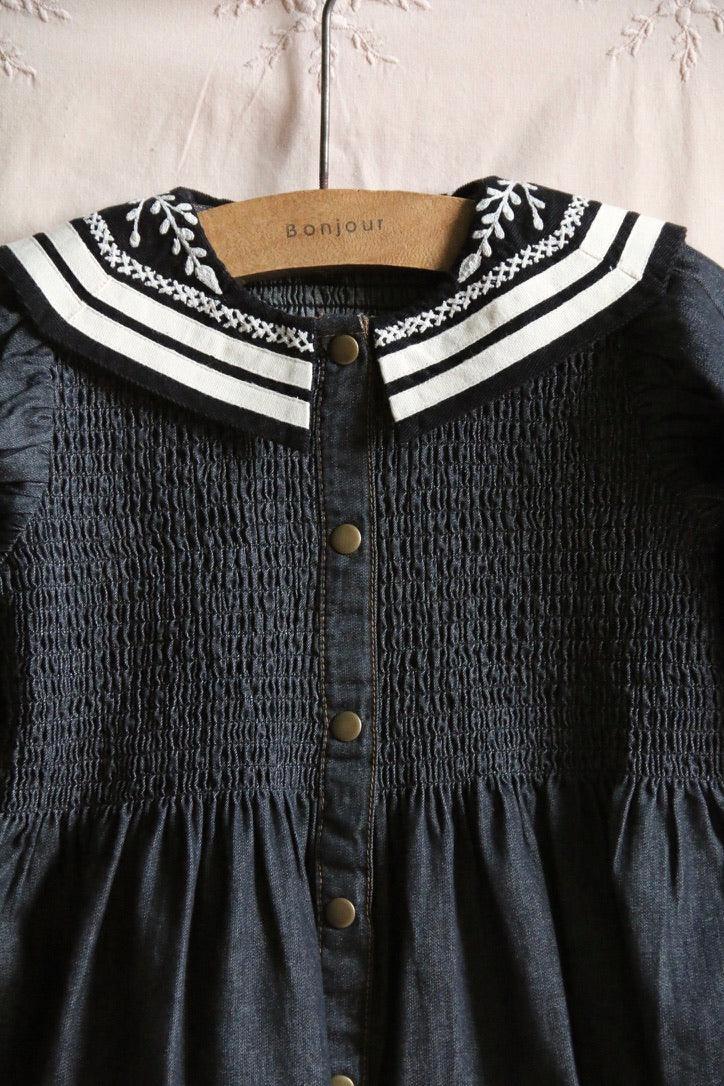 Dark blue smocked children's dress with embroidered sailor collar and front buttons