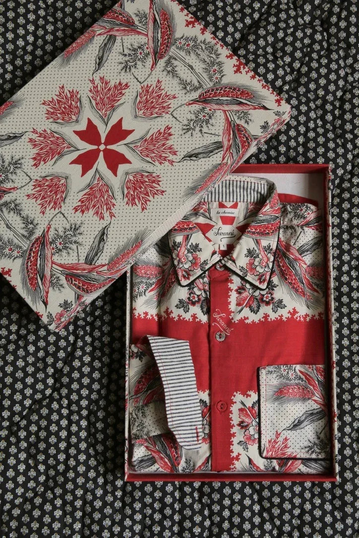 Floral print cotton shirt in gift box on patterned fabric background