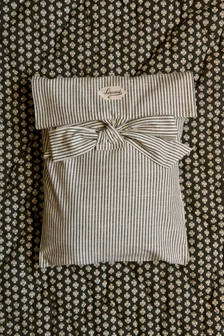 Striped fabric pouch with a bow on floral quilted bedding, kids bedding and accessories