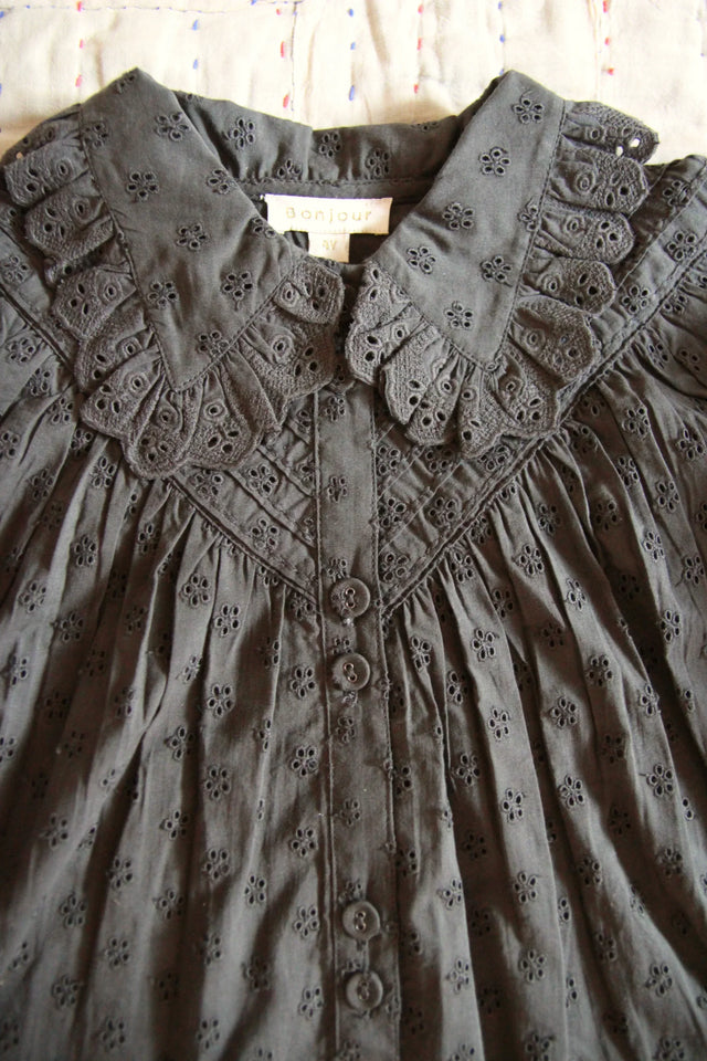 Dark grey embroidered cotton blouse with ruffled collar and floral eyelet details