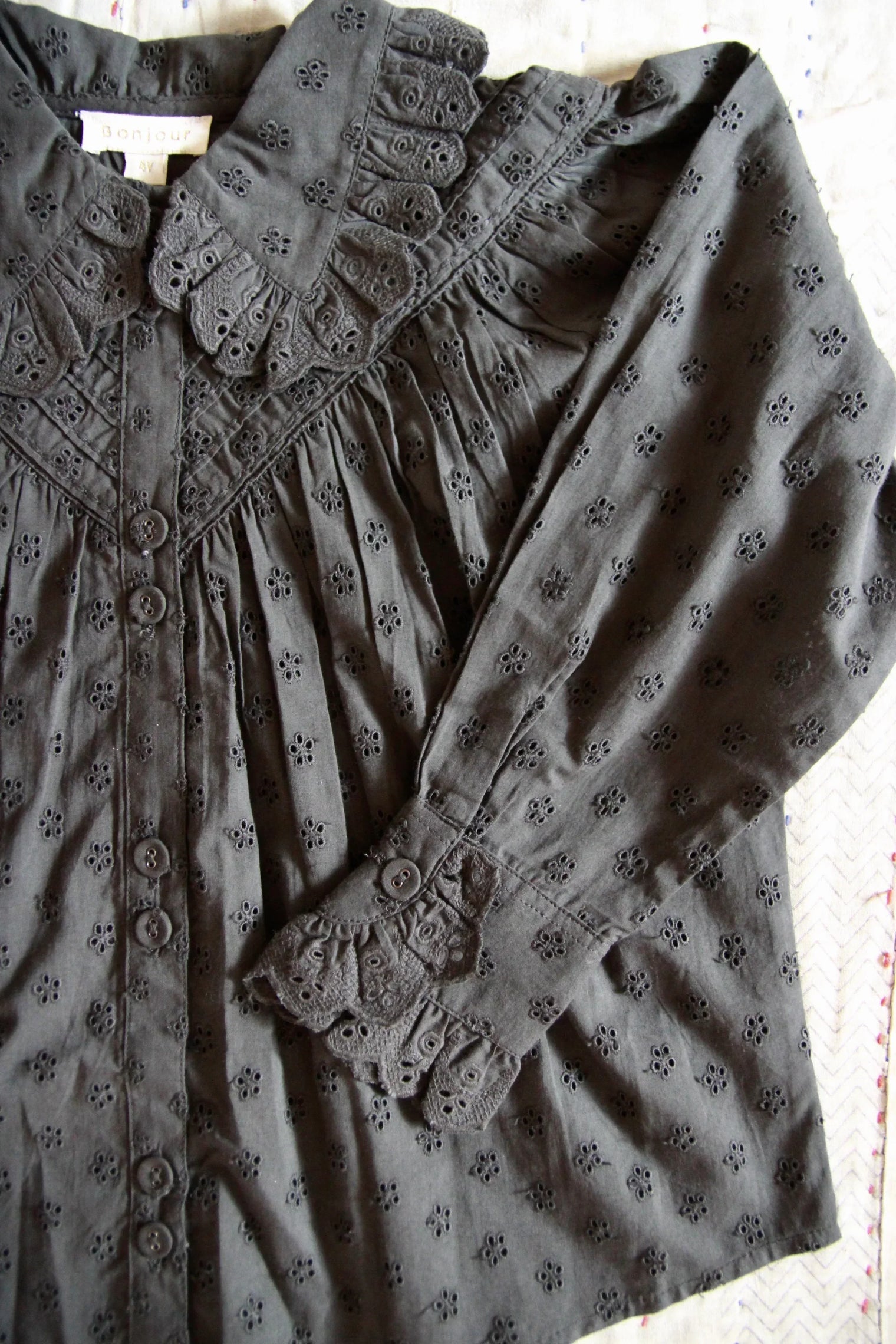 Black embroidered long-sleeve kids blouse with lace collar and floral eyelet detail