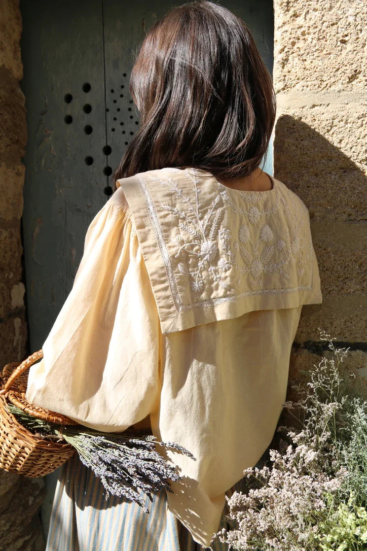 Butter-colored blouse with embroidered sailor collar
