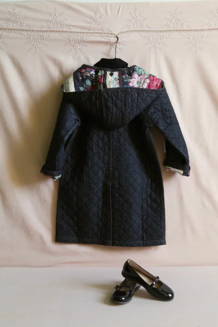 Quilted children's coat with floral hood detail, paired with black patent Mary Jane shoes
