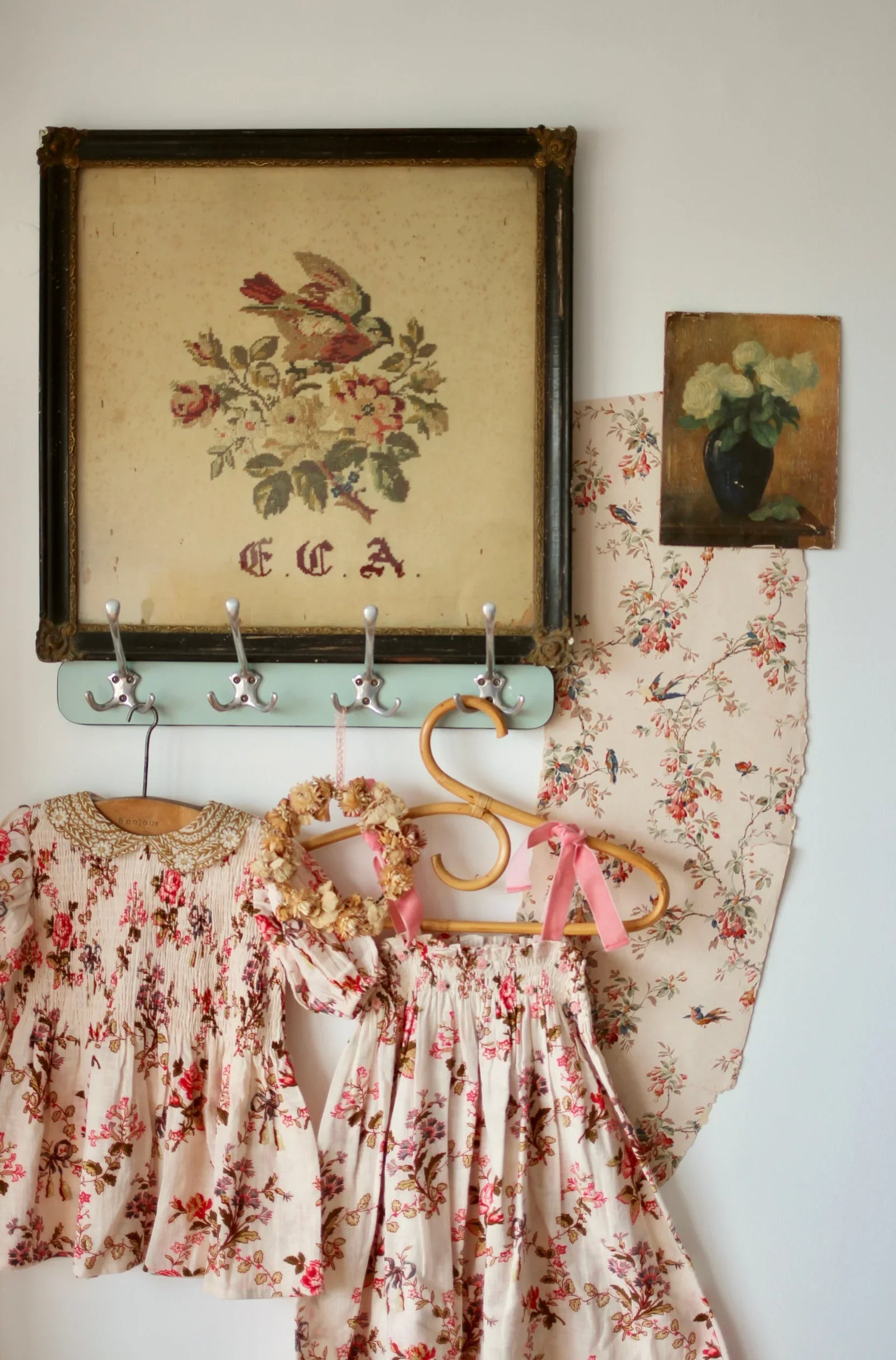 Floral print girls' dress and skirt with vintage floral wall art and hooks display