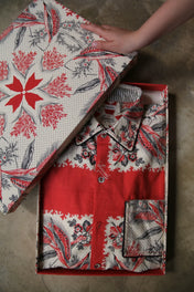 Children’s floral print shirt in red and white, neatly folded in a matching gift box