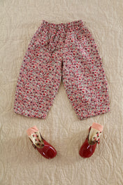 Bonjour floral print children's trousers with red patent leather shoes and socks.