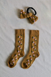 Children’s mustard yellow socks and matching hair bow with pink and green floral pattern