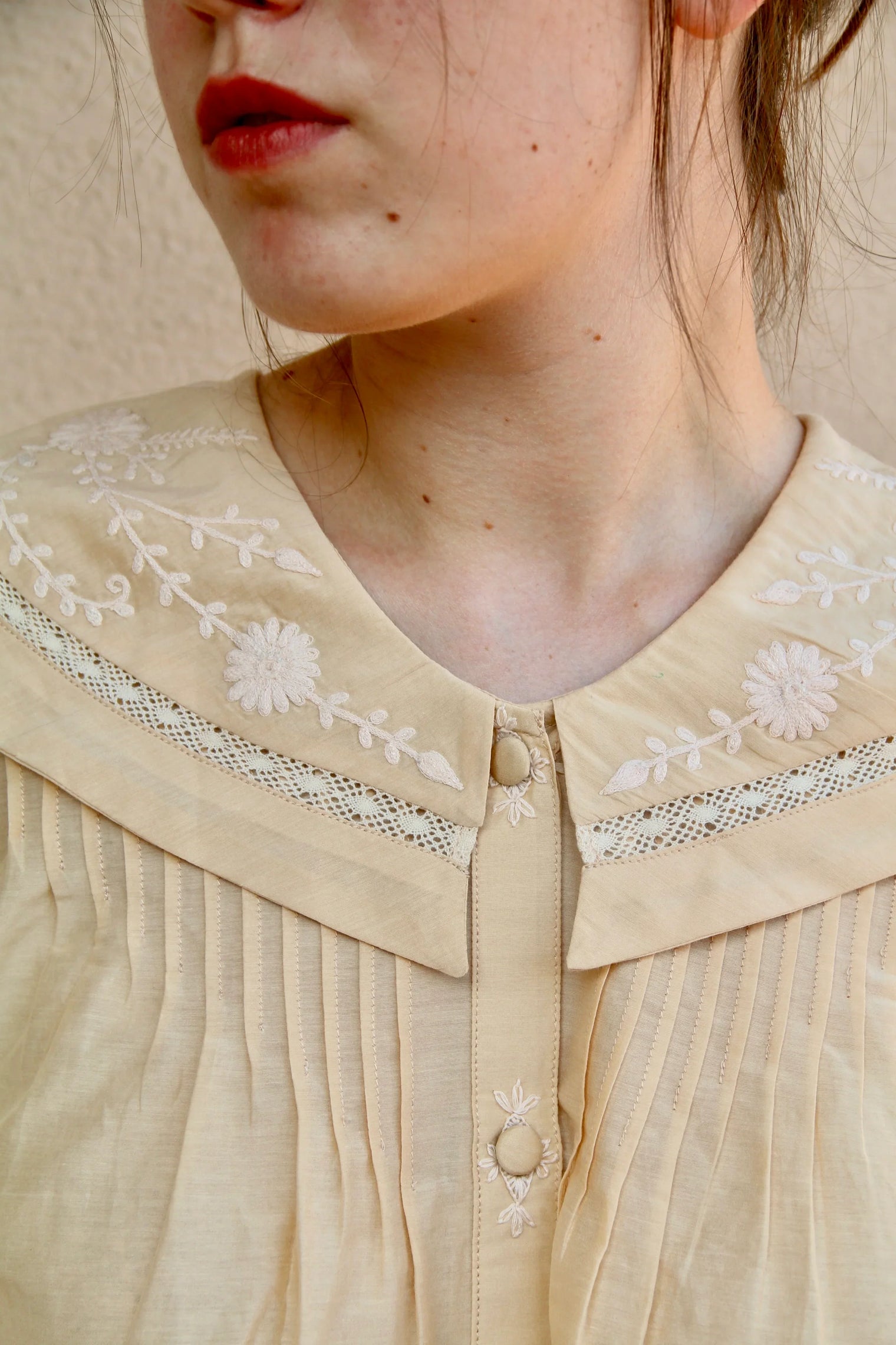 Butter-colored blouse with embroidered sailor collar