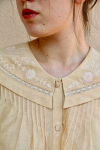 Butter-colored blouse with embroidered sailor collar