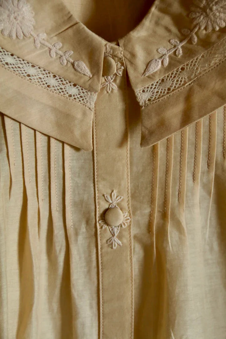 Butter-colored blouse with embroidered sailor collar