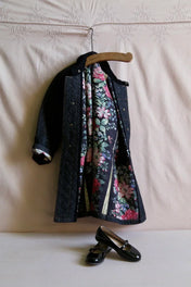 Children's quilted coat with floral lining on hanger and black patent Mary Jane shoes