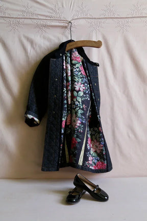Children's quilted coat with floral lining on hanger and black patent Mary Jane shoes