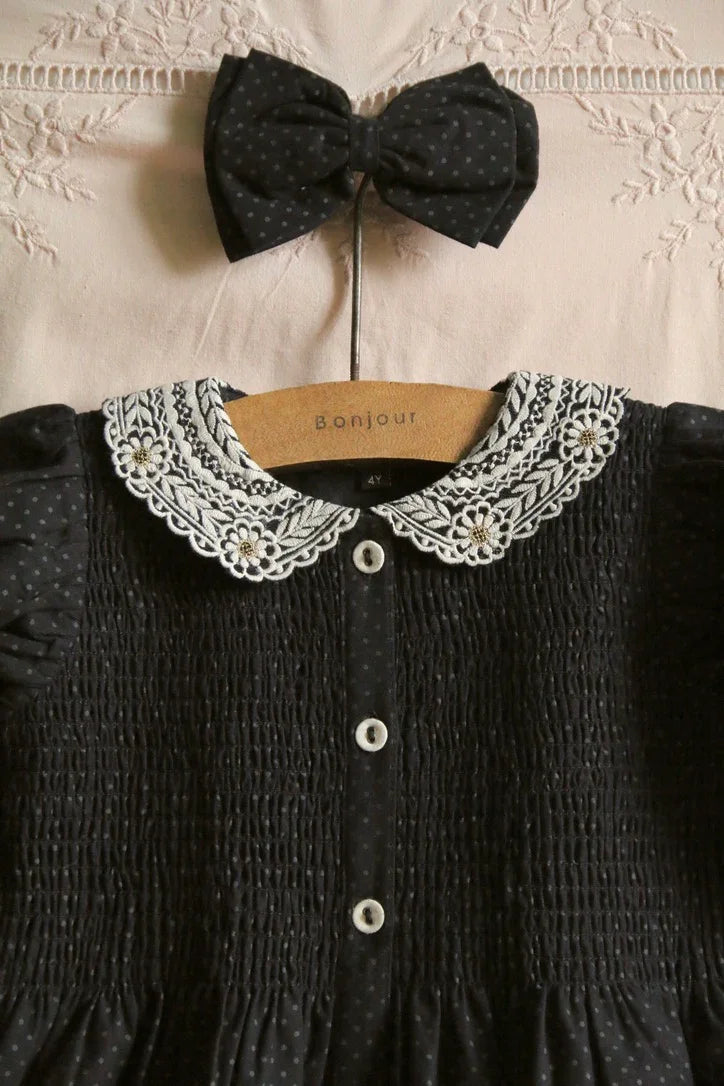 Black polka dot tunic and matching hair clip