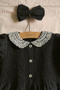 Black polka dot tunic and matching hair clip