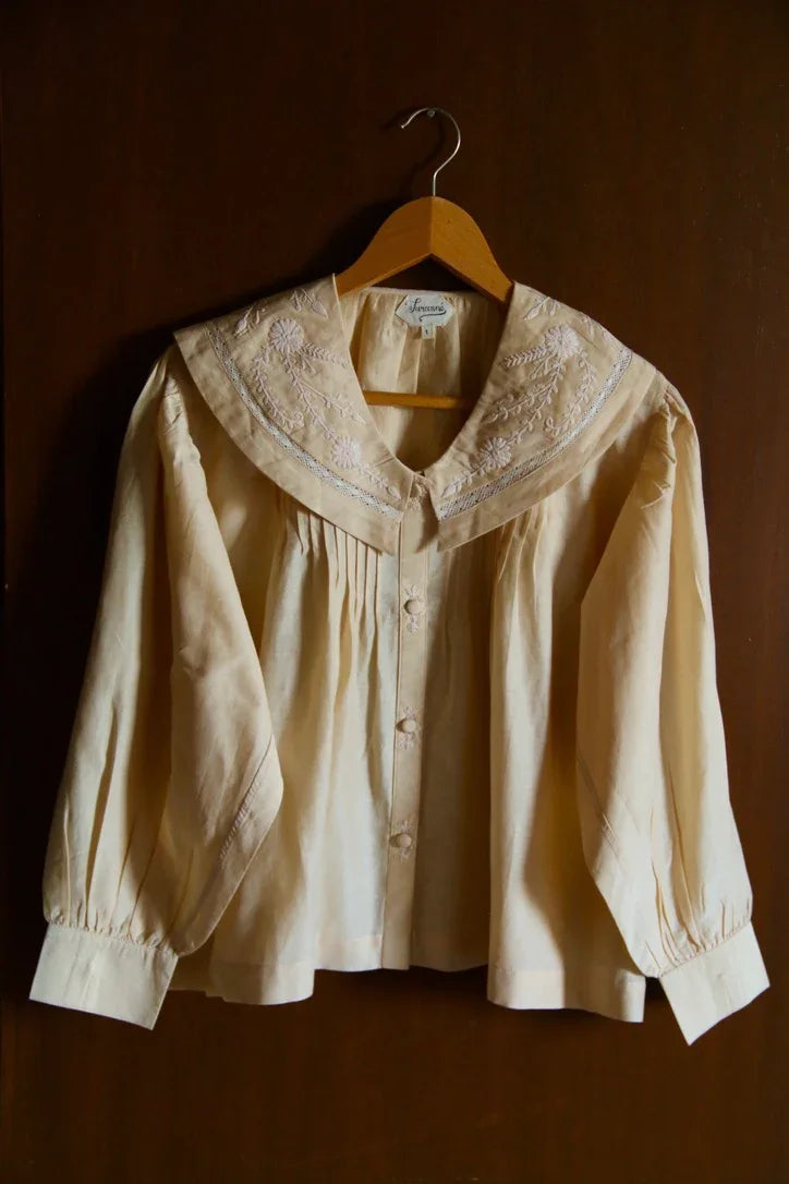 Butter-colored blouse with embroidered sailor collar