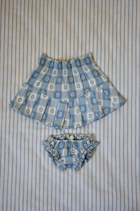 Blue gingham skirt and matching bloomers with daisy print for children on striped fabric