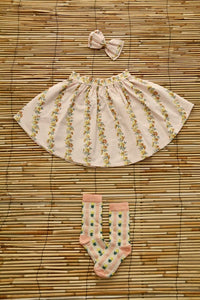Jupe farandole de fleurs et barrette noeud pour les cheveux